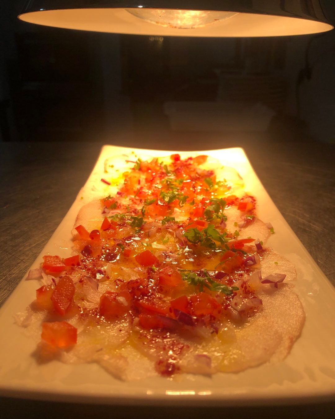 Carpaccio de corvina y vinagreta de grosellas en Badajoz